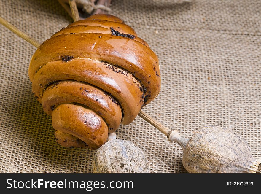 Freshly  baked poppy bun over sacking