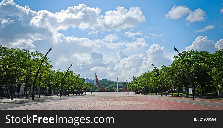 Square Of Public Park With Blue Sky And Clouds