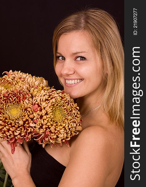 Romantic image of a young woman with yellow chrysanthemums..