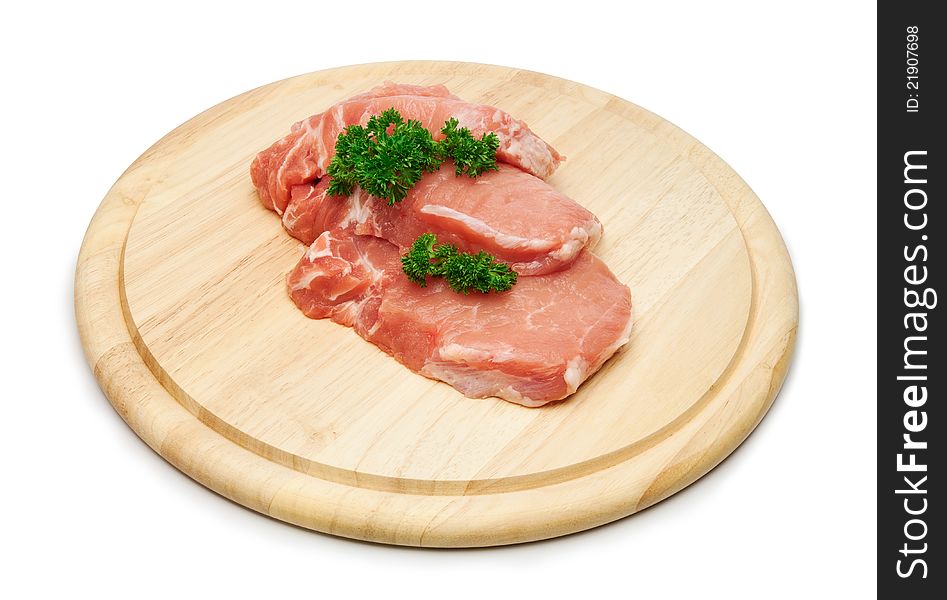 Fresh raw pork steak meat on wooden board.