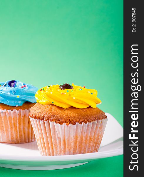 Delicious cupcake on green background.