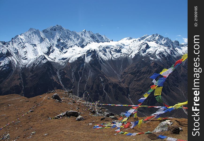 Prayer flags on a mountain-peak in the Langtang-valley, Nepal. At 4984 m. altitude.