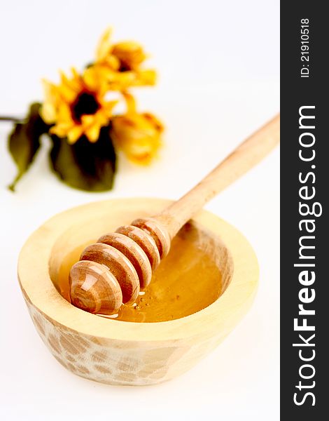 Honey in a wooden pot  on white background. Honey in a wooden pot  on white background
