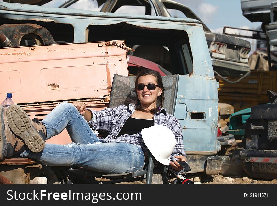 Woman relaxing in a landfill after use auto. Woman relaxing in a landfill after use auto