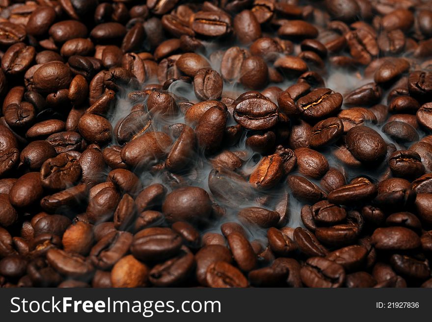Roasted coffee beans with smoke. Roasted coffee beans with smoke