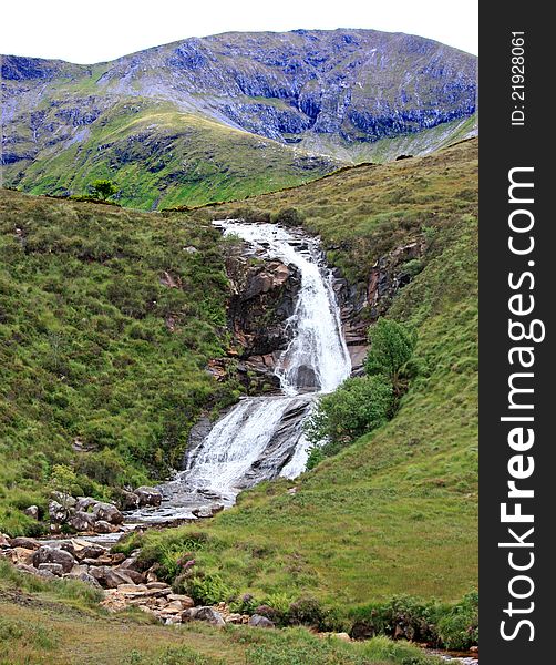 A Waterfall Flowing Over a Rocky Mountainside. A Waterfall Flowing Over a Rocky Mountainside.