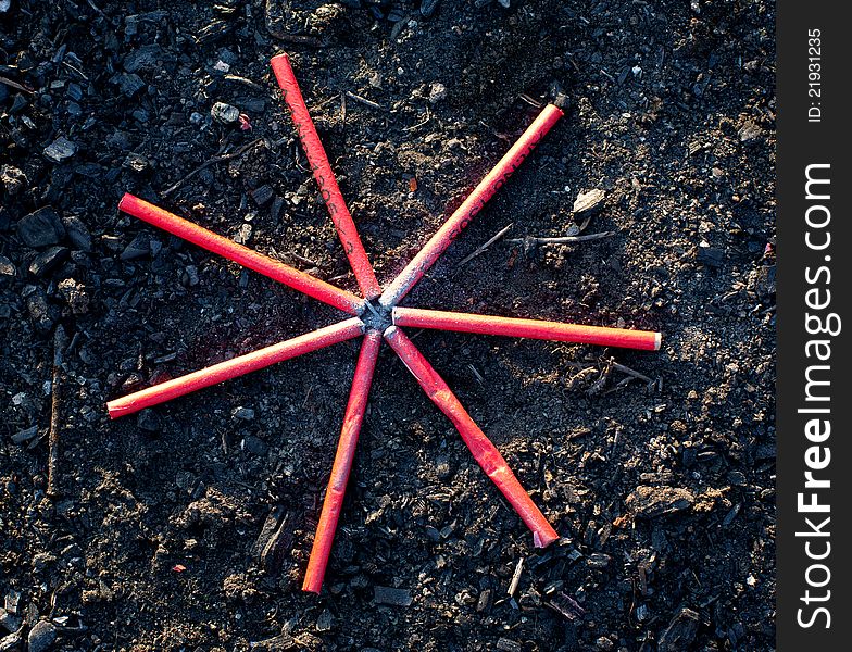 Firecrackers ready to explode, arranged in star shape on ground