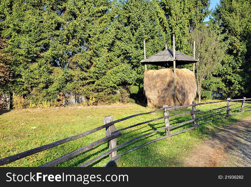 Haycock and old wooden fence in generic transylvania village. Haycock and old wooden fence in generic transylvania village