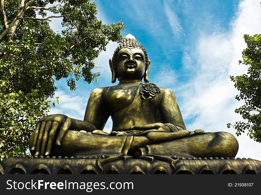 Buddha statue between the bo tree