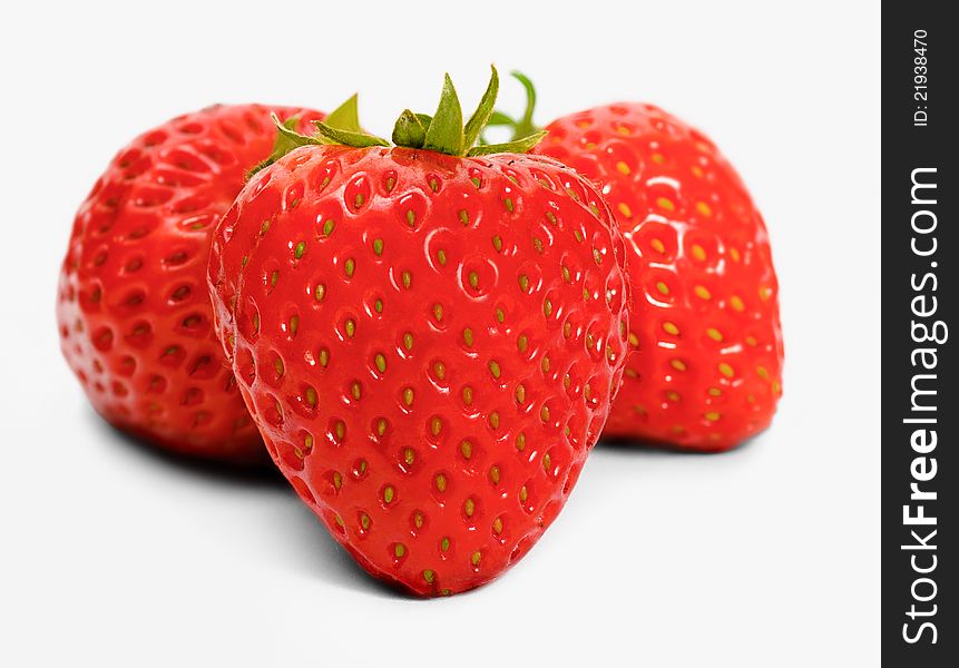 Three fresh strawberries on white background
