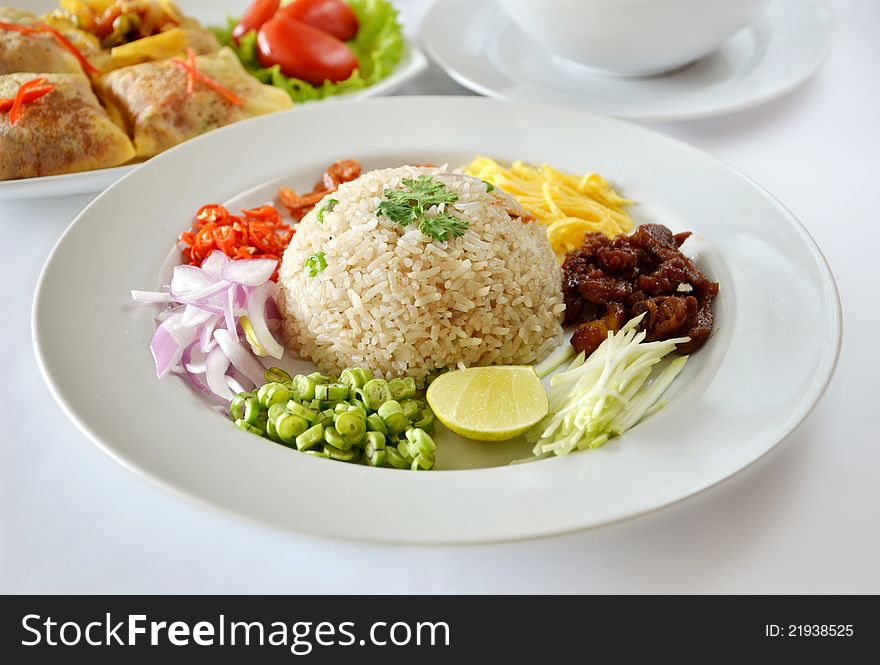 Mixed cooked rice with shrimp paste sauce and fresh vegetable , Thai food on table