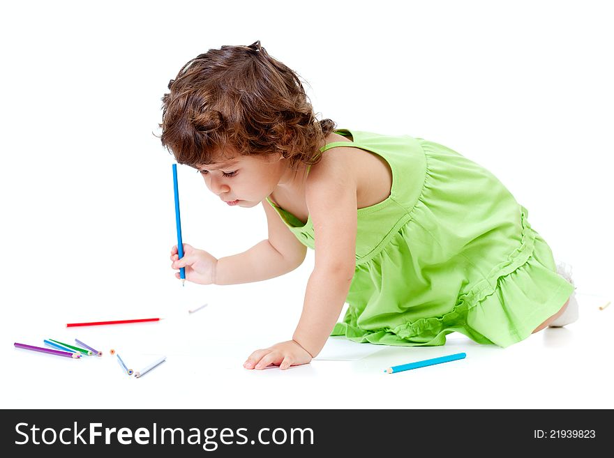 Little girl with blue pencil in studio
