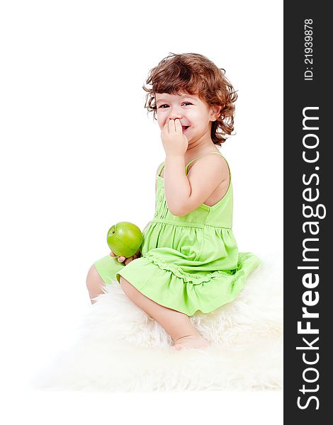 Adorable little girl eating green apple studio