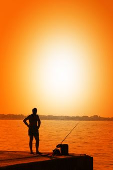 Man Fishing On The Pier Royalty Free Stock Images