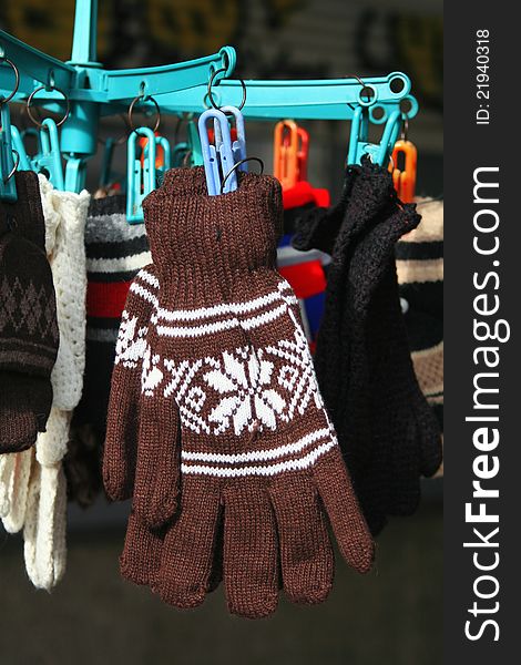 Woolen knitted gloves are sold in a street shop