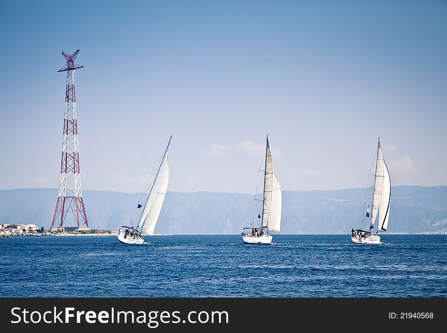 Sailing ship yachts with white sails at the open sea