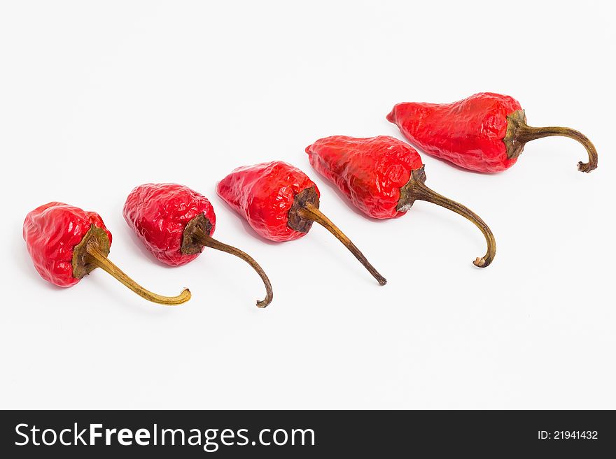 Red hot chilli peppers on white background