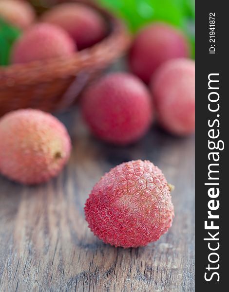 Fresh lychees fruit on wooden table, selective focus