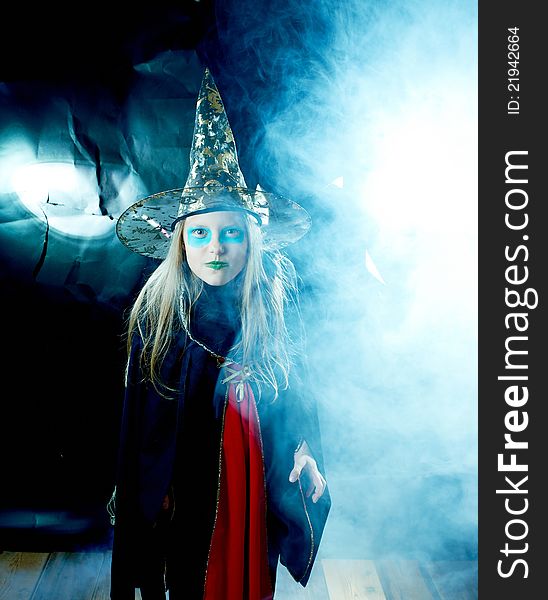 Attractive witch girl in spooky robe and hat. Attractive witch girl in spooky robe and hat