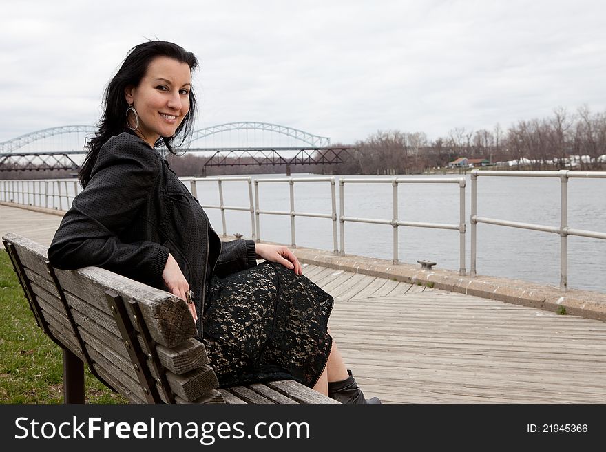 Fourty year old brunette on a bench overlooking the Connecticut river in Middletown CT. Fourty year old brunette on a bench overlooking the Connecticut river in Middletown CT