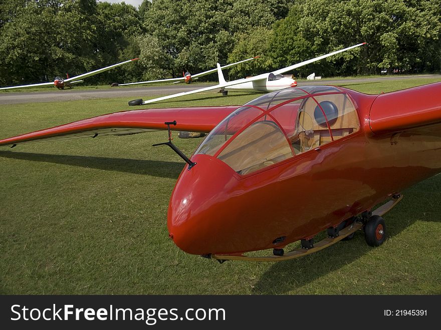 A gull winged glider, rare and one of only a few every made,Fit to fly and in wonderful red color,in the back ground other vintage gliders. A gull winged glider, rare and one of only a few every made,Fit to fly and in wonderful red color,in the back ground other vintage gliders.