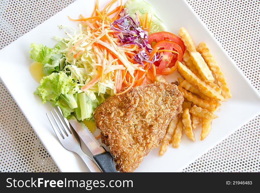 Fried fish. Served with potato and salad. Fried fish. Served with potato and salad.