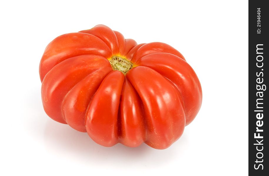 Single red tomato on white