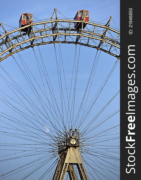 Sunlit ferris wheel of Vienna with little moon in the back. Sunlit ferris wheel of Vienna with little moon in the back