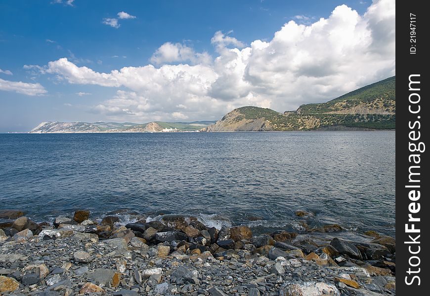 Summer landscape with sea rocks skies and clouds. Summer landscape with sea rocks skies and clouds