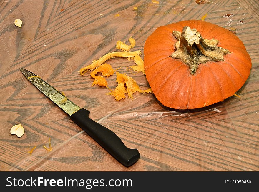 Still life of pumpkin top and knife after the traditional carving. Still life of pumpkin top and knife after the traditional carving