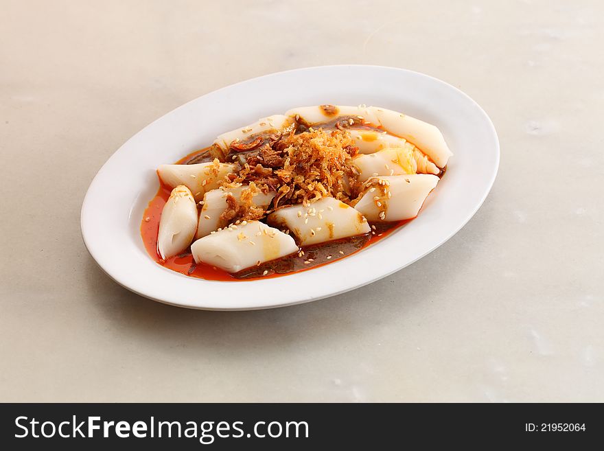 Asian plain rice noodle rolls with chilli sauce and sesame seeds