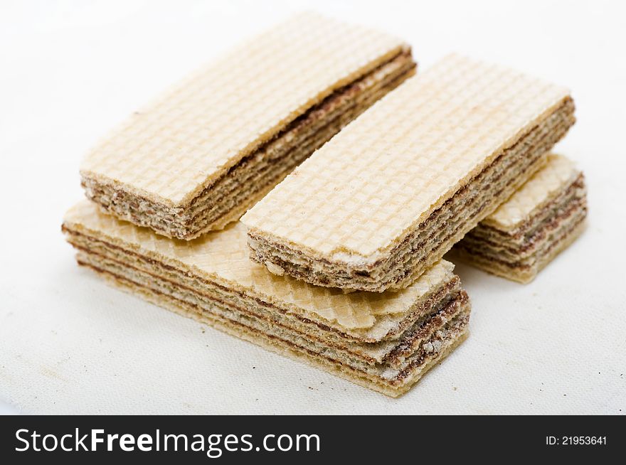 Chocolate wafer stacked over white background. Shot in the studio