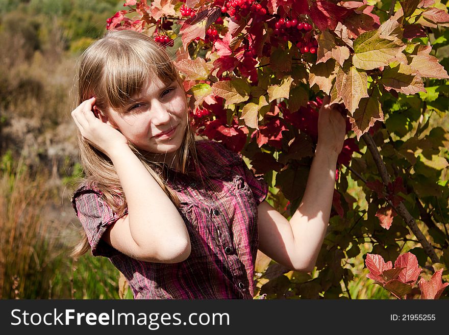 Girl near the ashberry bush shrub