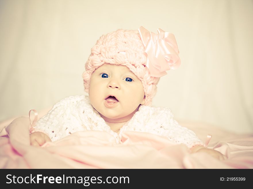 Cute baby girl in a pink hat