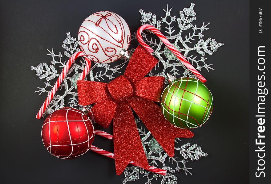 Christmas decorations of colorful ornaments, candy cane, ribbon and snowflakes.