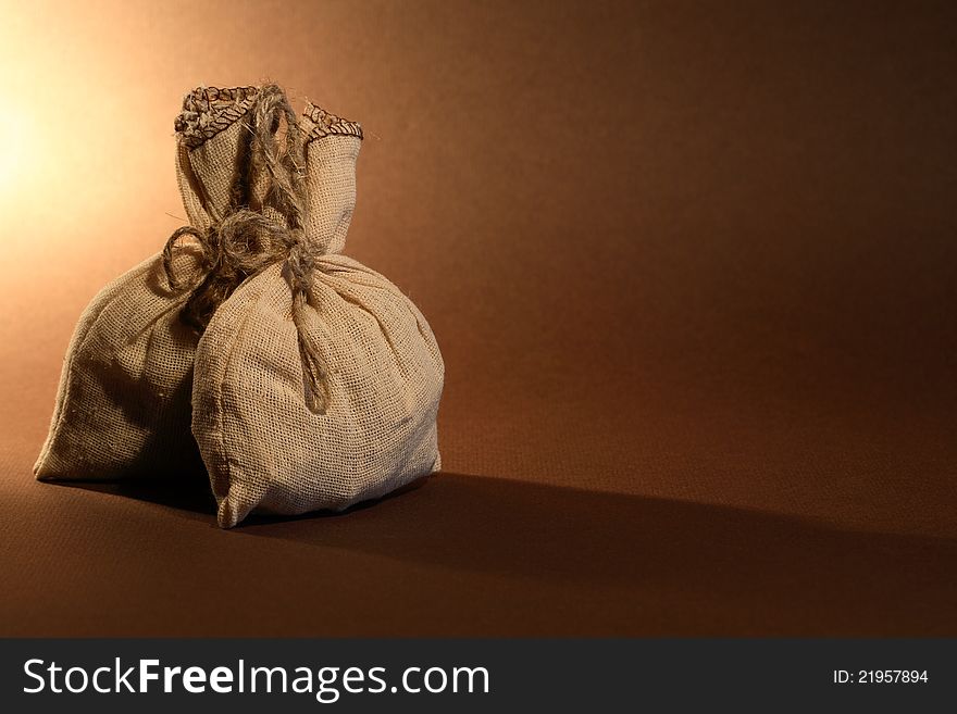 Storage concept. Two full burlap sacks on nice brown background with free space for text