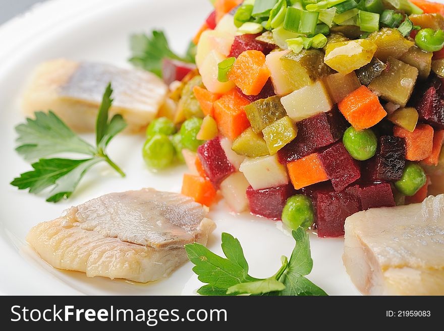 Chopped boiled vegetables with herring on plate. Chopped boiled vegetables with herring on plate