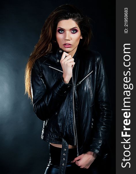 Portrait of young woman in a black leather jacket. Portrait of young woman in a black leather jacket.