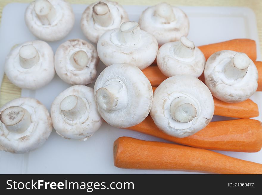 Carrots and mushrooms on the counter ready for cutting