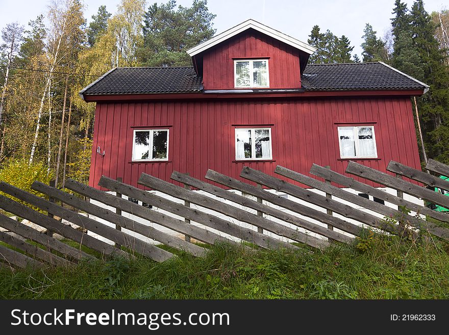 Red summer cottage surrounded by trees in Norway. Red summer cottage surrounded by trees in Norway