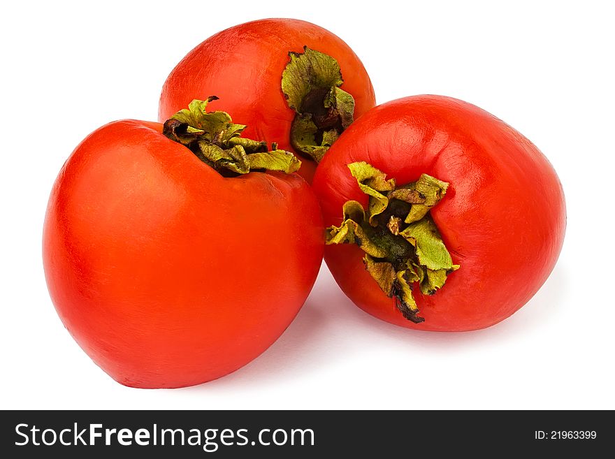 Three persimmons against white background