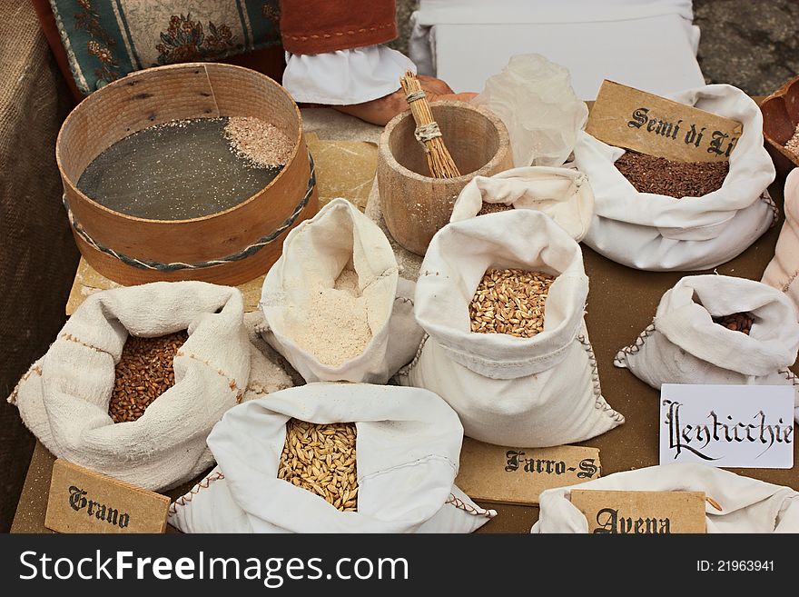 Reproduction of old grain store whit assortment of cereals, legumes and flour - wheat, oats, barley, spelt, ingredients of mediterranean diet