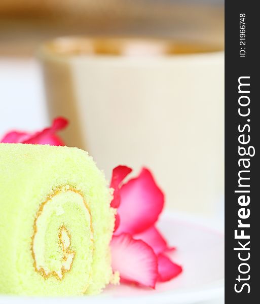 Roll cake and flower with coffee cup