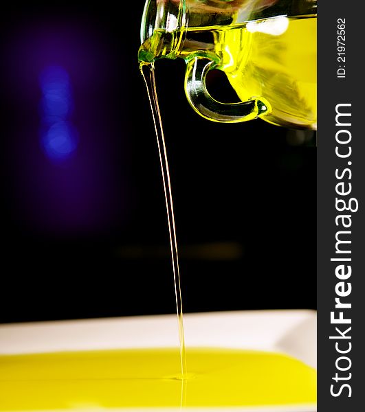 Olive oil glass bottle poring oil