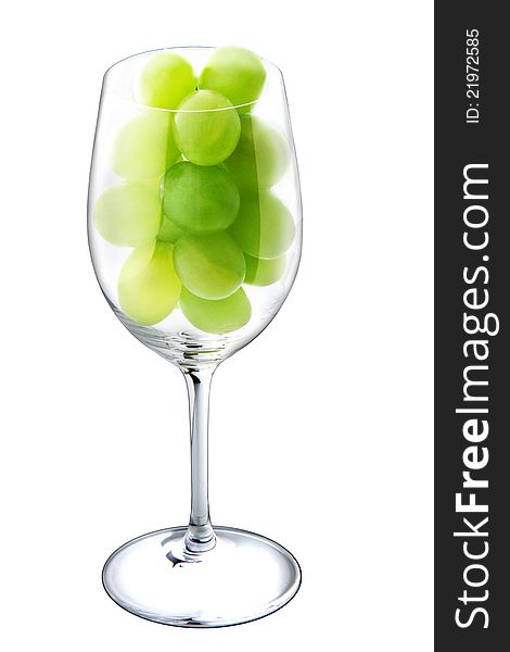 White wine glass with green grapes in the inside. White background. White wine glass with green grapes in the inside. White background.