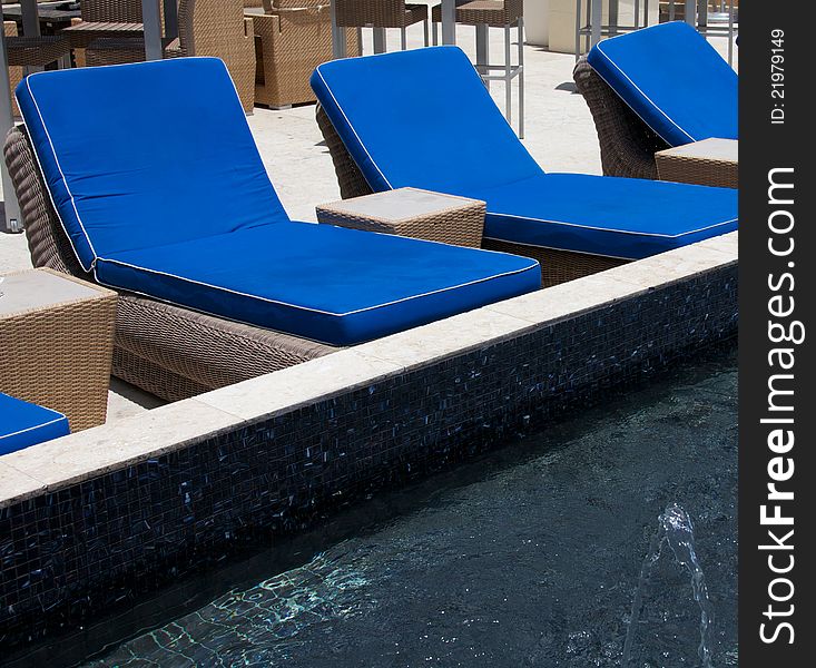 Blue lounge chairs beside wading pool
