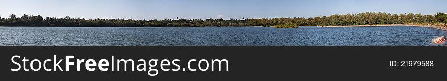 Beautiful panorama of lake ,Old red turned boat in the bank of  blue lake near stones