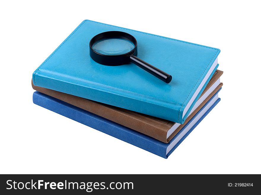 Three Books And Magnifying Lens