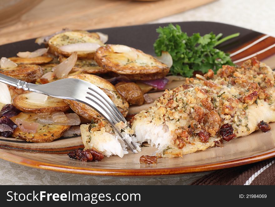 Breaded baked fish fillet with potatoes dinner. Breaded baked fish fillet with potatoes dinner