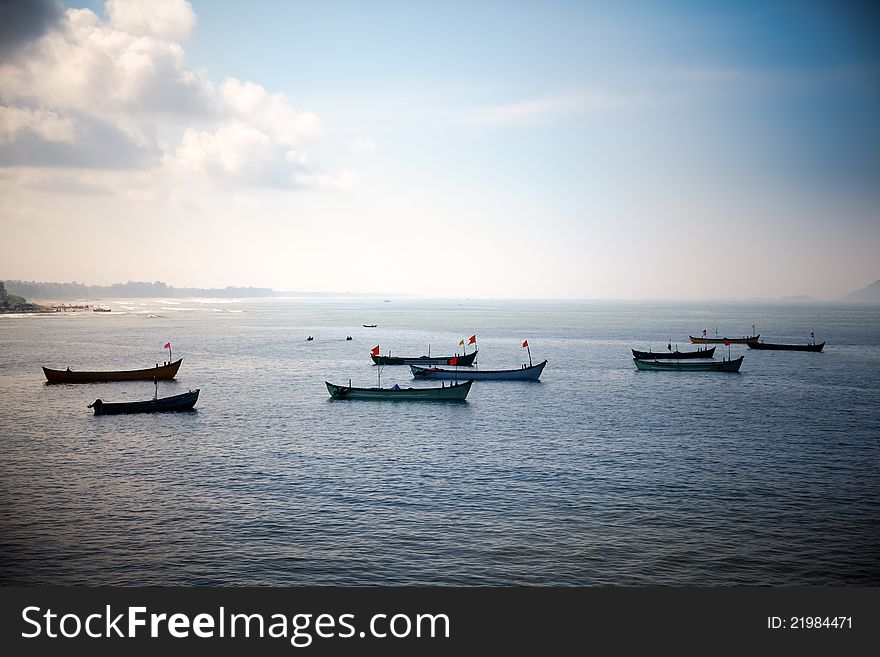 Group of small boats anchored in the blue waters of Arabian sea. murudeshwar Karnataka India. Group of small boats anchored in the blue waters of Arabian sea. murudeshwar Karnataka India